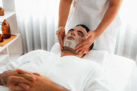 Serene modern daylight ambiance of spa salon, woman customer indulges in rejuvenating with facial skincare mask. Facial skin treatment and beauty cosmetology procedure for face. Quiescentの写真素材