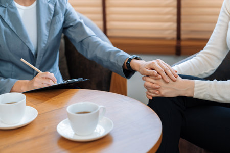 Psychological consultation on mental health or seeking help from professional, young patient on therapy session while psychiatrist making diagnostic on mental illness. Mental treatment session. Blitheの写真素材