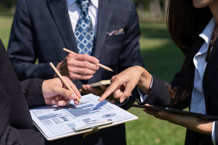 Group of asian business people presenting environmentally friendly development plan and sustainable technology project for greener future, establishing outdoor eco business office at natural park.Gyreの写真素材