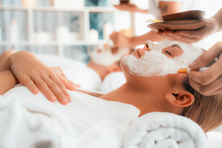Serene ambiance of spa salon, couple indulges in rejuvenating with luxurious face cream massage with modern daylight. Facial skin treatment and beauty care concept. Quiescentの写真素材