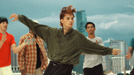 Professional asian break dancer practice B boy dance while multicultural friends at rooftop. Young...