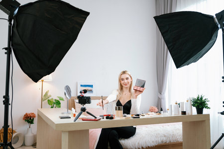 Young woman making beauty and cosmetic tutorial video content for social media. Beauty blogger...