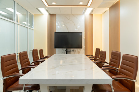 Modern meeting room interior with television for remote working. Modern white meeting table with...