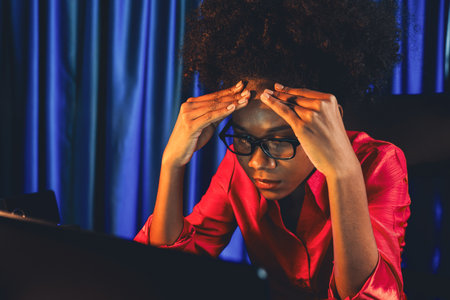 Working African woman blogger concentrated on the laptop screen with serious face, searching marketing data analysis, conclusion overall document on database for meeting report. Tastemaker.の写真素材