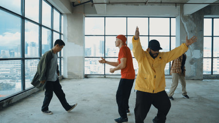 Multicultural dancer practice street dance and move to hip-hop music. Professional hipster group perform dance to freestyle music at building with sky scrapper view. Outdoor sport 2024. Endeavor.の写真素材
