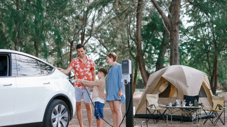 Outdoor adventure and family vacation camping in nature travel by eco friendly car for sustainable...