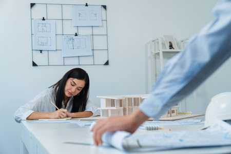 Professional asian male project manager hand puts the map on meeting table while beautiful colleague...