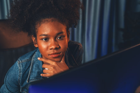 Young African American creator woman with serious face, thinking carefully and looking at final...