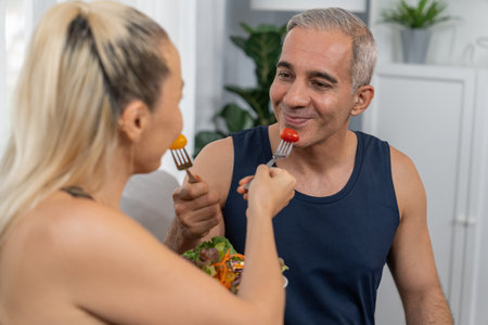 Healthy senior couple in sportswear with a bowl of fruit and vegetable. Healthy cuisine nutrition...