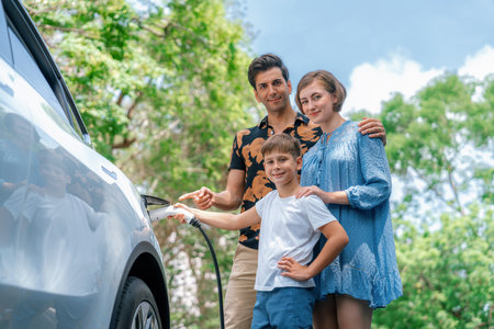 Family road trip vacation with electric vehicle, lovely family recharge EV car with green and clean energy. Natural and eco friendly car travel for sustainable environment. Perpetualの写真素材