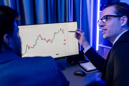 Two stock exchange traders cooperating digital currency or market online focusing on dynamic data...
