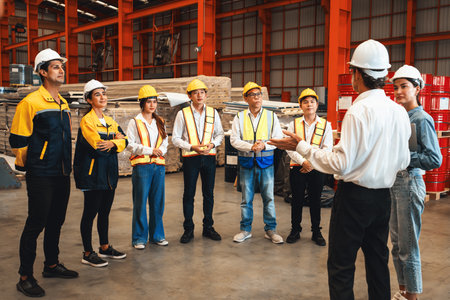Collective factory worker and engineer gather for meeting with factory executive or manager, discussing plan and industry training program on-site work heavy industrial steel workshop. Exemplifyingの写真素材