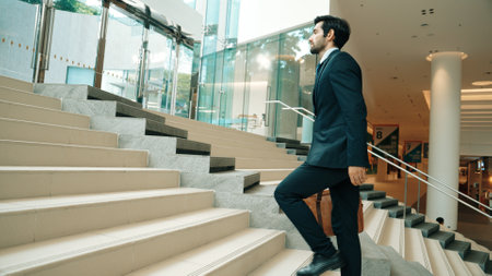 Professional business man going up the stairs. Successful man going up the stairs while explore a...