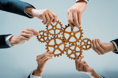 Business team joining cogwheel in circular together symbolize successful group of business partnership and strong collective teamwork unity in workplace community with productive efficiency. Shrewdの写真素材