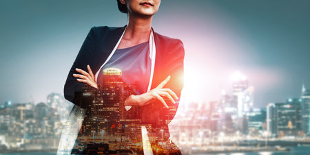 Double Exposure Image of Business Person on modern city background. Future business and communication technology concept. Surreal futuristic cityscape and abstract multiple exposure interface. udsの写真素材