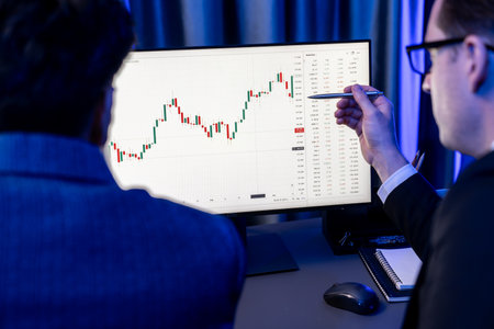 Two stock exchange traders cooperating digital currency or market online focusing on dynamic data...