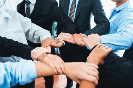 Multicultural business people holding hand together in circle. Unity teamwork in office business...