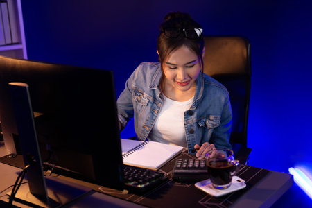 Successful young beautiful asian creative calculating digit of profit of sales target report on...