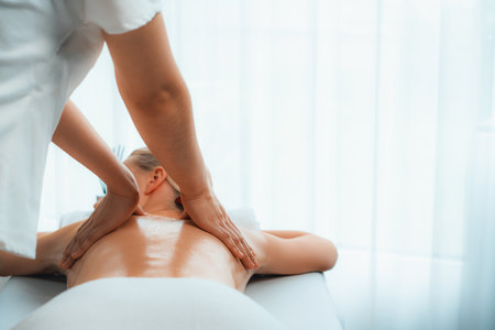 Caucasian woman customer enjoying relaxing anti-stress spa massage and pampering with beauty skin recreation leisure in day light ambient salon spa at luxury resort or hotel. Quiescentの写真素材