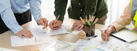 Professional architect team and safety engineer with safety helmet brainstorming about architectural...