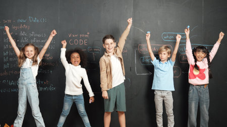 Diverse student raised hands up while standing at blackboard written with engineering prompt or...