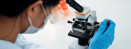 Laboratory researcher develop new medicine or cure using microscope. Technological advance of...