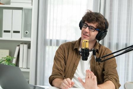 Host channel of influencer using headphone and mic talking with listeners on social media with laptop in life coaching and training marketing planning to customer target at studio office. Gusher.の写真素材