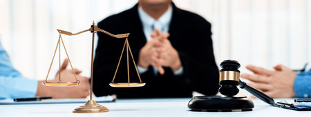 Focused gavel hammer and balance scale of justice on blurred background of lawyer acting as mediator to broke compromise to resolve legal business dispute with negotiation. Panorama Rigidの写真素材