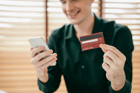 Young man using laptop with credit card for internet banking, online shopping E commerce by online...
