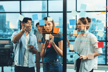 Smart business team working together, brainstorming idea at glass wall. Group of businesspeople...
