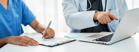 Professional various team of medical working and planning medical treatment at hospital table...