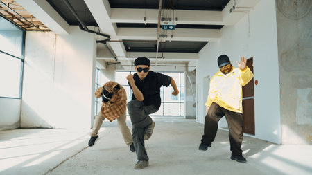 Multicultural hipster group looking at camera while perform break dancing at building with sky scrapper or city view. Street dancer team looking at dancer performance. Outdoor sport 2024. Endeavor.の写真素材
