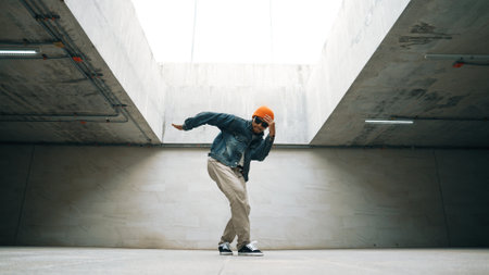 Stylish happy hipster perform break dance or freestyle foot step in building. Professional break dancer practice b-boy dance while wear stylish cloth. Modern lifestyle. Outdoor sport 2024. Sprightly.の写真素材