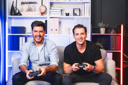Winner and loser players of buddy friend gamers playing video game on TV using joysticks in studio...