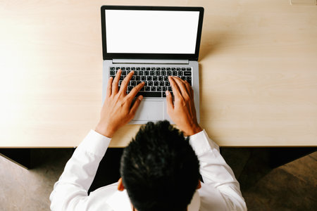 Business person or office worker using laptop computer while sitting at desk. udsの写真素材