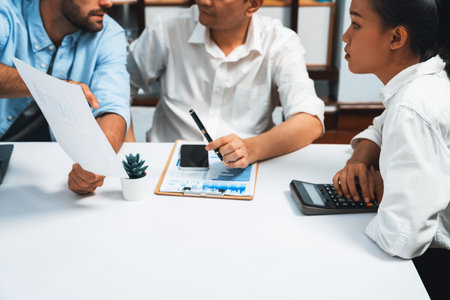 Diverse corporate audit team or company bookkeeper and accountant consultant calculate account expenses and income budget for tax refunds using calculators in busy workspace. Prudentの写真素材