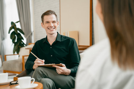 Psychological consultation gaining improvement on mental problem, happy young female patient doing therapy session while psychiatrist making diagnostic on mental illness. Unveilingの写真素材