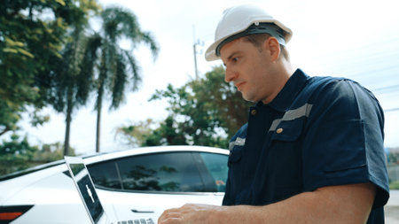 Qualified technician working on home EV charging station installation, making troubleshooting and...