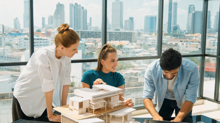 Smart architect team discussion about house design while handsome male worker present idea by using laptop. Group of professional engineer sharing, brainstorming design. Business design. Traceryの写真素材
