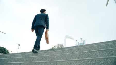 Top view of smart business man walking up stairs with bag in the hand. Professional project manager...