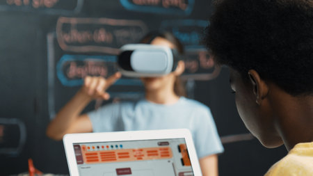 Closeup of smart african student coding or programing system at blackboard with web develop plan while young girl playing in metaworld at blackboard with engineering prompt. Innovation. Edification.の写真素材