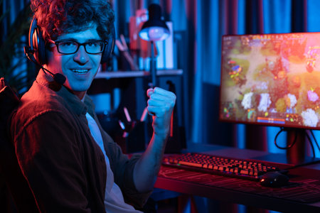 Host channel of young gaming streamer looking at camera to fist up in fighting Moba battle arena...