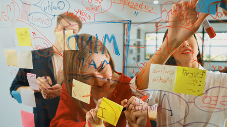 Creative business team brainstorming and sharing marketing idea about start up project by writing...