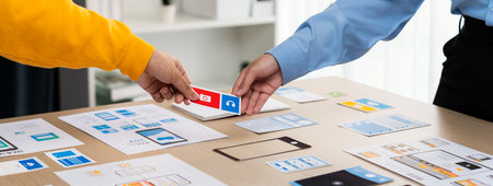 Panorama banner of startup company employee planning on user interface prototype for mobile application or website in office. UX UI designer brainstorm user friendly interface plan. Synergicの写真素材