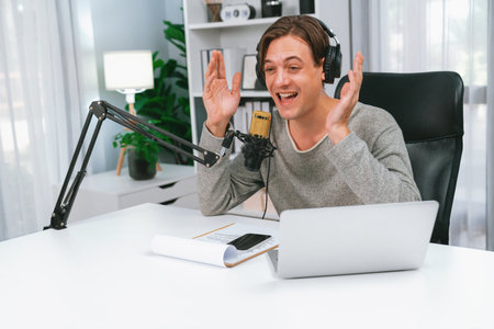 Host channel in smiling smart broadcaster recording, talking show with script and smartphone on desk...