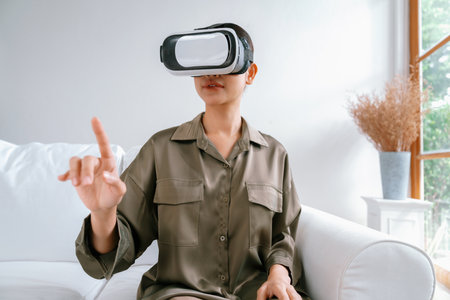 Young woman using virtual reality VR goggle at home for uttermost online shopping experience. The...
