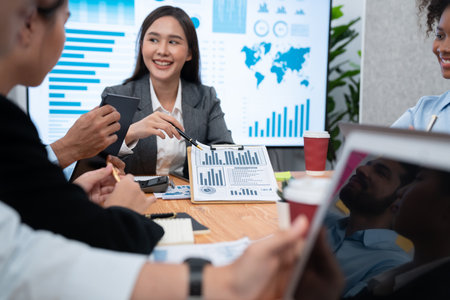 Multiracial analyst team use BI dashboard data to analyze financial report on meeting table. Group of diverse business people utilize data analysis by FIntech for business marketing decision. Concordの写真素材