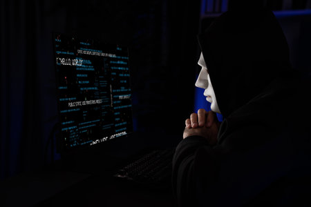 White criminal anonymous mask as hack programmer trying to approach main database server drive system on main computer in competitor company to ransom in virus privacy system at night time. Surmise.の写真素材