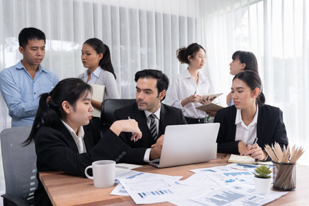 Diverse group of business analyst team analyzing financial data report paper on office table. Chart and graph dashboard by business intelligence analysis for strategic marketing planning Meticulousの写真素材