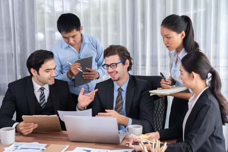 Diverse of business people from various ethnic group working in modern office environment. Productive and multi ethnic office workers engage in discussion for strategic business marketing. Meticulousの写真素材